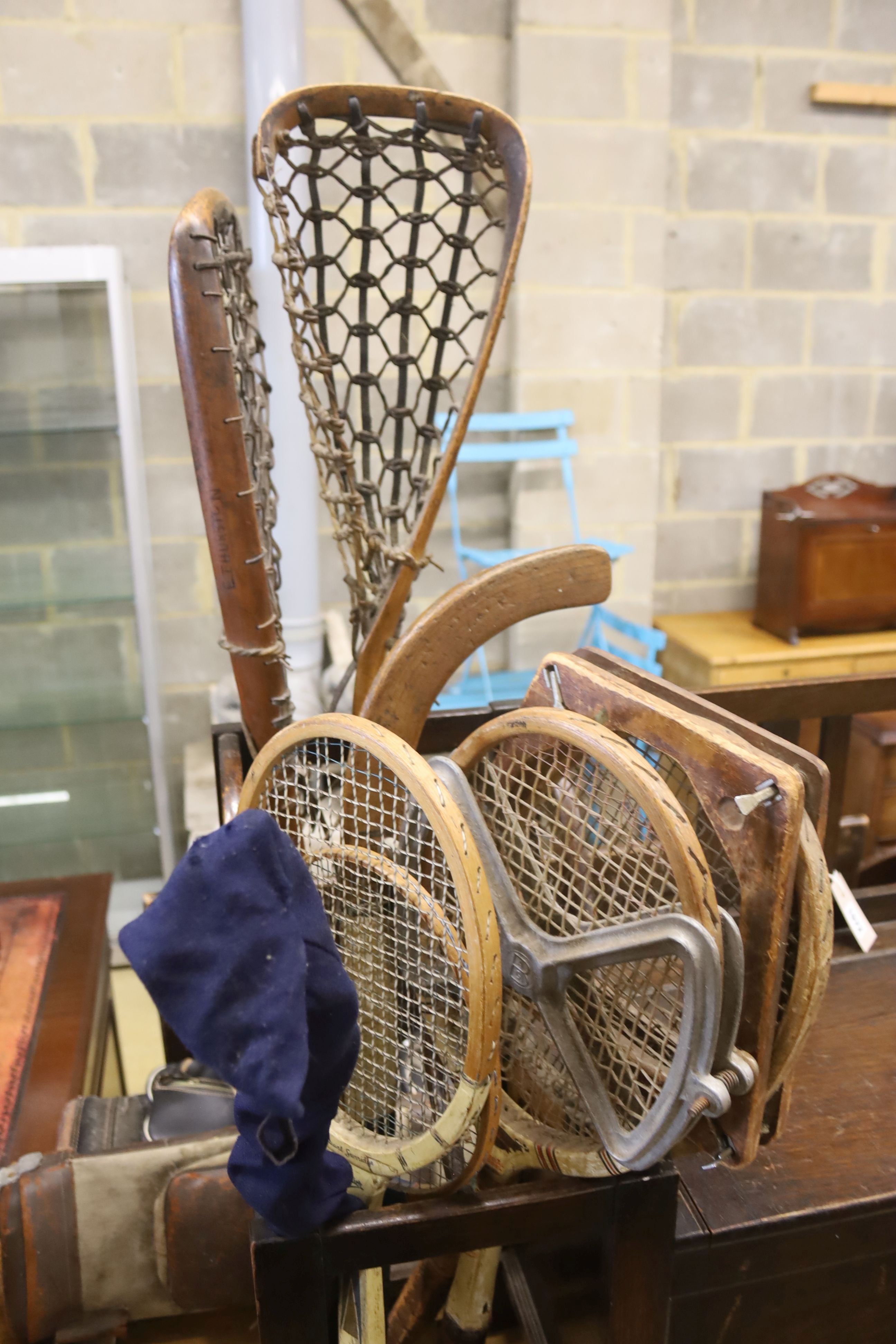 A 1920's oak hall seat together with a collection of vintage lacrosse sticks, golf clubs, etc.